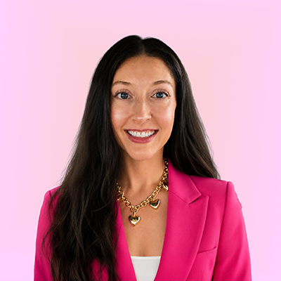 Desirée Clark wearing a magenta blazer.